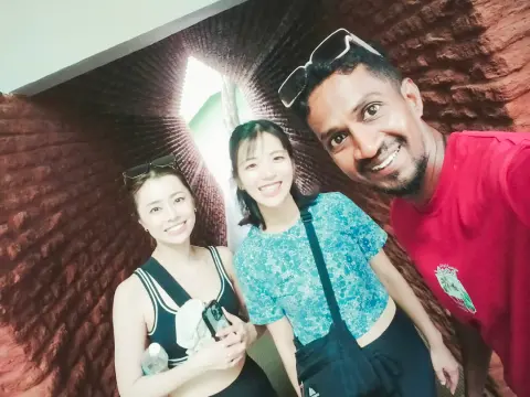 Two guests and their driver-guide taking a selfie in a red-brick archway
