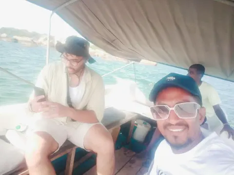 Guests and their driver-guide in a canopy boat out on the water